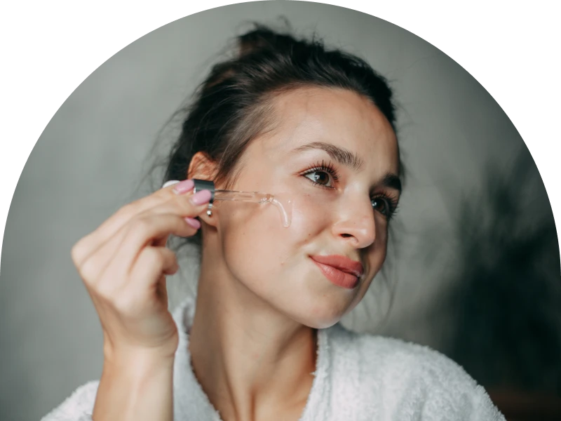 Woman applying serum to her face