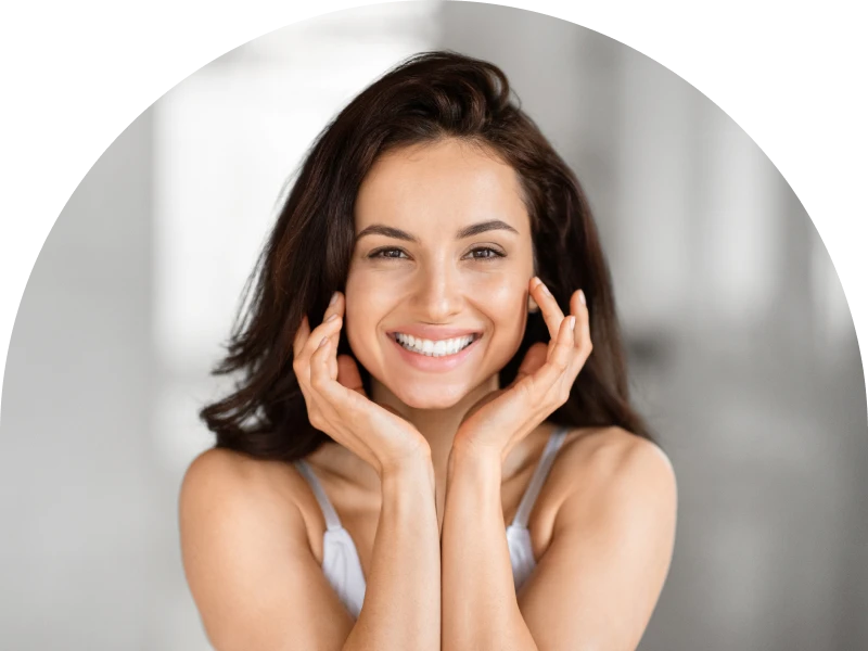 Smiling woman with hands on face